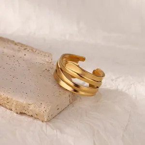 Detailed view of an 18K gold plated triple layered irregular stainless steel ring