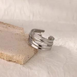 Macro detail of triple-layer irregular geometric silver ring on stone display