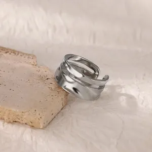 Macro shot of silver wide band ring featuring triple-layer irregular wave texture
