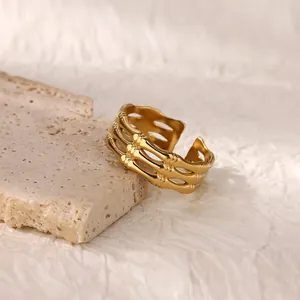 Detailed macro view of 18K gold plated hollow bamboo style irregular open ring on stone