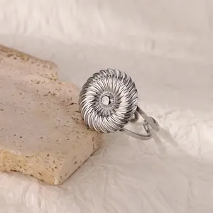 Macro detail of silver spiral texture on adjustable stainless steel geometric ring