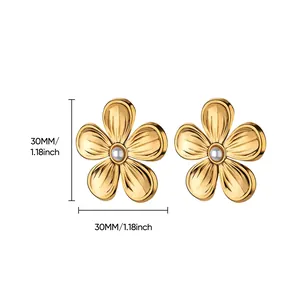 Detail shot of 18K gold plated flower earrings with white pearl centers and 30mm size