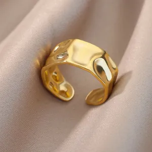Macro detail of irregular hammered texture on 18K gold plated adjustable open ring