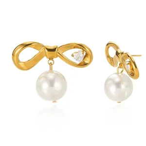 Boucles d'oreilles nœud dorées 18K avec perles blanches et détails en zircon cœur