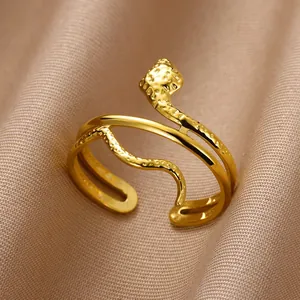 Macro shot of gold snake ring featuring hammered texture and a double-layered open band design