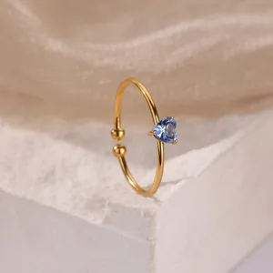 Close-up of heart-shaped blue zircon on adjustable gold-plated stainless steel ring