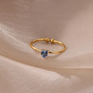 Detailed macro of 18K gold plated heart ring with blue sapphire zircon inlay