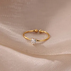 Detail of 18K gold plated heart zircon ring on champagne silk background