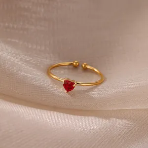 Macro detail of red heart-shaped zircon ring with adjustable 18K gold-plated band