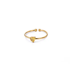 Detail of a 18K gold plated open ring featuring a yellow heart-shaped zircon stone