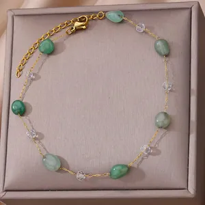 Detailed view of 18K gold plated anklet with green natural stones and crystals