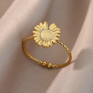 Detalle macro de un anillo de margarita dorada con banda trenzada y pétalos texturizados