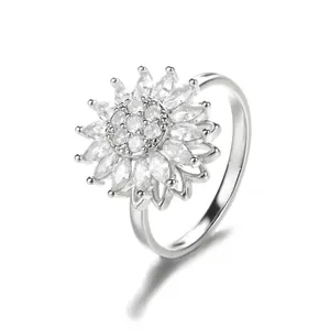 Macro shot of silver rotating flower ring with sparkling zircon petals and 18K gold plating