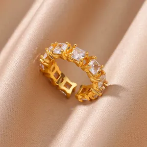 Macro shot of 18K gold plated ring with square cut zircons on silk background