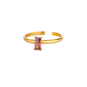 Close-up of gold-plated adjustable ring featuring a rectangular red zircon stone