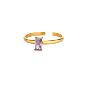 Detailed close-up of a golden adjustable ring featuring a rectangular purple zircon stone