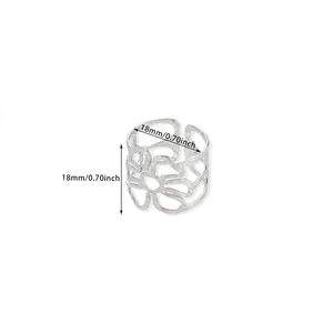 Detailed macro view of silver floral hollow lace pattern on adjustable stainless steel ring
