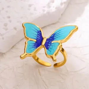 Elegant gold-plated stainless steel open ring featuring a blue enamel butterfly design