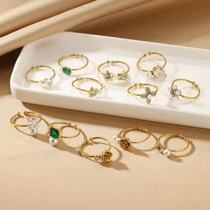 12-piece gold ring set for women with pearls and crystals on silk background