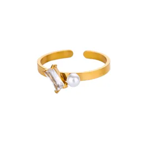 Detail of gold-plated ring featuring a rectangle zircon and white faux pearl accent