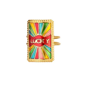 Macro detail of golden enamel ring with colorful rays and LUCKY engraving on rectangle face