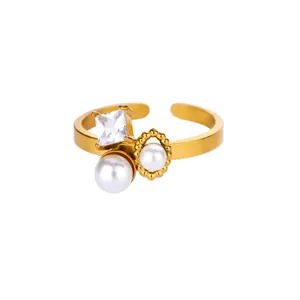 Detailed macro view of golden open ring with square cubic zirconia and white pearls