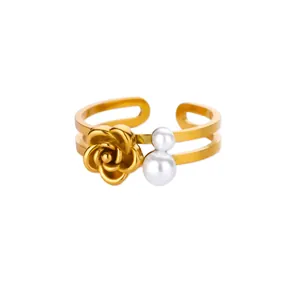 Detail of adjustable gold ring featuring a 3D rose flower and two white faux pearls
