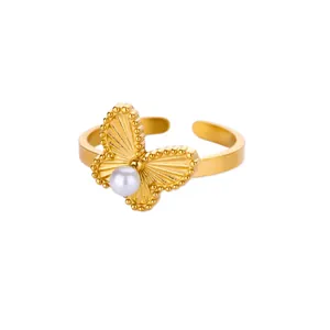 Detail of golden butterfly ring with pearl inlay and beaded open band design