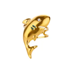 Macro detail of golden shark ring with crystal eye, green enamel gills and tiered band