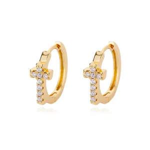 Minimalist gold hoop earrings featuring cross pendants with shimmering zircon stones