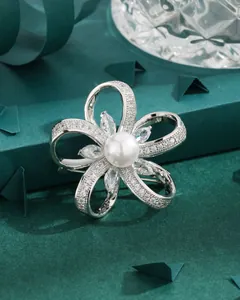 Elegant silver flower brooch with white pearls and sparkling cubic zirconia stones
