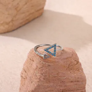 Detail of adjustable silver ring with turquoise triangle and geometric hollow design