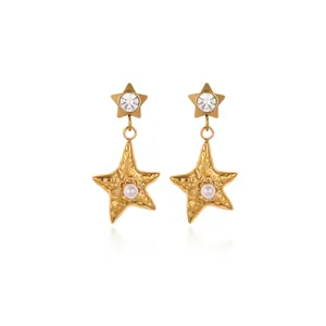 Star-shaped gold titanium steel earrings with pearls and rhinestones on white background
