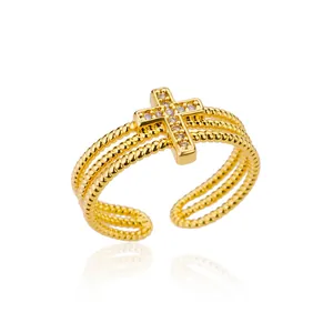 Adjustable golden multi-layer rope ring featuring a cross charm with white zircons