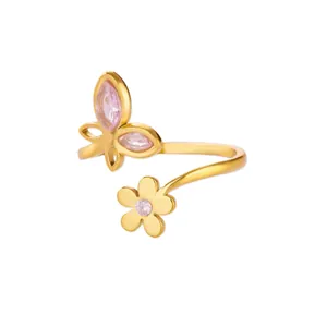 Detailed macro view of 18K gold butterfly and pink zircon flower open ring design