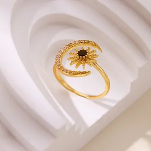 Anello di lusso oro con stella e luna e zirconi su supporto geometrico bianco