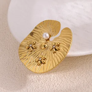 Elegant gold lotus leaf brooch with small flowers and white pearl on ceramic plate