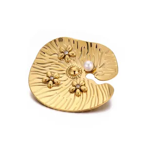 Elegant gold lotus leaf brooch featuring delicate flowers and a lustrous white pearl