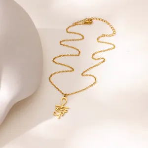 Detailed close-up of golden Ankh and Eye of Horus pendant on adjustable O-chain necklace