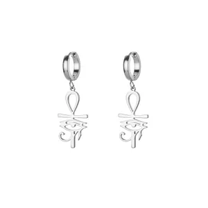 Macro detail of silver Ankh cross and Eye of Horus charms on stainless steel hoop earrings