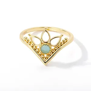 Detail of vintage crown ring with gold plating and light blue gemstone inlay