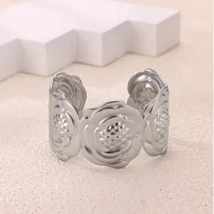 Macro detail of silver cuff bracelet featuring embossed 3D rose flower patterns