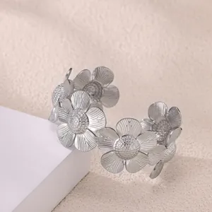 Detailed macro view of matte silver daisy flower cuff bracelet with intricate petal texture