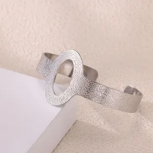 Detailed view of silver open cuff bracelet with hammered texture and oval cutout design