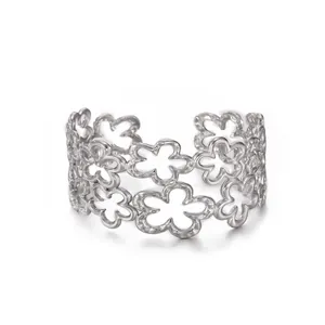 Detail of silver hollow floral open ring featuring double-layered petal pattern design