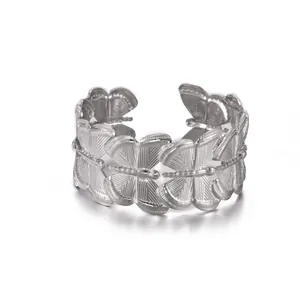 Detailed view of silver butterfly wrap ring with engraved wings and adjustable open band