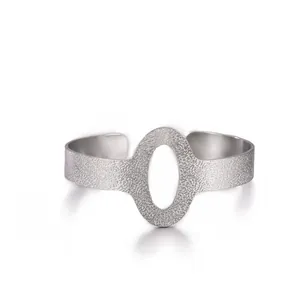 Detailed view of silver open cuff bracelet with hammered texture and oval cutout design