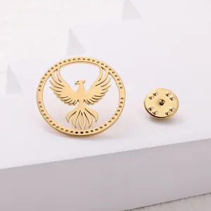 Golden phoenix eagle stainless steel brooch pin displayed on a minimalist white pedestal