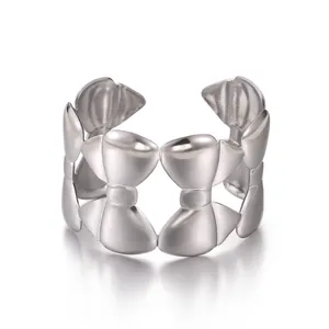 Detail of silver-tone open bangle with interconnected hollow bow-knot design elements