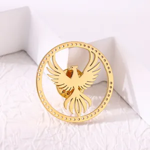 Golden stainless steel phoenix brooch with circular cutout design and butterfly clasp